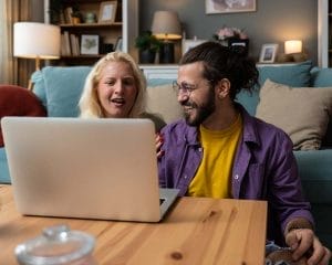 A young couple sits at home, participating in an online therapy session with a counsellor.  An example of couples counselling in Edmundston, representing an online counselling session.